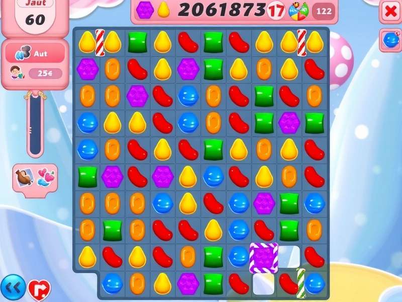 Colorful candy pieces scattered on a blue surface, representing Candy Crush Saga boosters